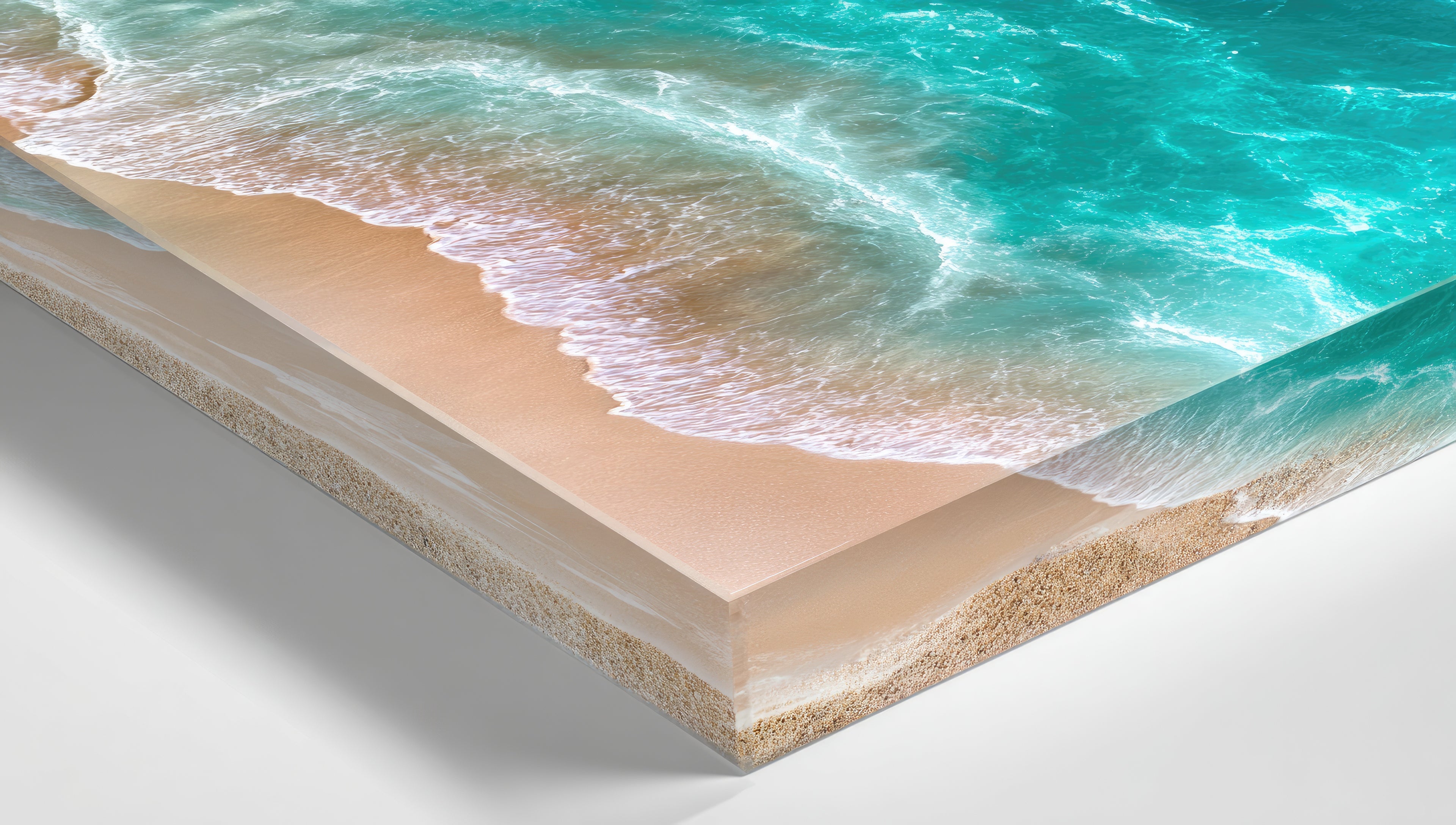 Close-up of a beach scene with sand and ocean waves printed on an acrylic block